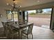 Inviting dining room with backyard views, modern lighting and table setting for six at 6429 E Jean Dr, Scottsdale, AZ 85254