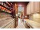 Charming bar area features stone countertops, wine storage and leads into a cozy living room at 10471 E White Feather Ln, Scottsdale, AZ 85262