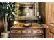 Charming powder room featuring rustic vanity, mirror, wood accents and ample natural light at 10471 E White Feather Ln, Scottsdale, AZ 85262