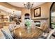 Formal dining area showcasing fireplace, chandelier, views and seating for six at 10471 E White Feather Ln, Scottsdale, AZ 85262