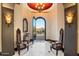 Grand entryway with decorative chairs and a grand view of the desert landscape through the arched doorway at 10471 E White Feather Ln, Scottsdale, AZ 85262