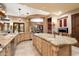 Spacious kitchen featuring granite countertops, travertine floors, stainless appliances and island at 10471 E White Feather Ln, Scottsdale, AZ 85262