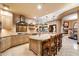 Gourmet kitchen with large island, breakfast bar, travertine backsplash, and stainless steel appliances at 10471 E White Feather Ln, Scottsdale, AZ 85262