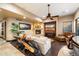 Cozy living room with stone fireplace, ceiling fan and comfortable seating at 10471 E White Feather Ln, Scottsdale, AZ 85262