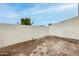 Enclosed backyard features a unique stone and concrete mix, providing a private outdoor space at 1051 S Dobson Rd # 117, Mesa, AZ 85202