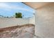 Enclosed backyard features a unique stone and concrete mix, providing a private outdoor space at 1051 S Dobson Rd # 117, Mesa, AZ 85202