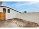 Enclosed backyard features a unique stone and concrete mix, providing a private outdoor space at 1051 S Dobson Rd # 117, Mesa, AZ 85202