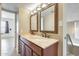 Bathroom boasts double sinks with granite counters and framed mirrors at 1051 S Dobson Rd # 117, Mesa, AZ 85202