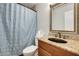 Cozy bathroom includes a vanity, toilet, and shower with a decorative curtain at 1051 S Dobson Rd # 117, Mesa, AZ 85202