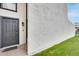 Charming front entrance showcasing a dark gray door and well-kept lawn with partial blue sky at 1051 S Dobson Rd # 117, Mesa, AZ 85202