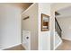 Inviting hallway featuring tile floors, wall décor, coat hooks, and staircase leading to upper level at 1051 S Dobson Rd # 117, Mesa, AZ 85202