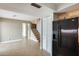 Kitchen area, featuring a refrigerator and adjacent living spaces, great for entertaining and modern living at 1051 S Dobson Rd # 117, Mesa, AZ 85202