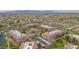 Expansive aerial view showcases the entire neighborhood, with a community pool and lush landscaping at 14950 W Mountain View Blvd # 3105, Surprise, AZ 85374