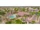 Aerial view of the community shows the pool, lush landscaping, and beautiful buildings at 14950 W Mountain View Blvd # 3105, Surprise, AZ 85374