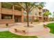 Well-maintained building exterior with mature tree and landscaped common area at 14950 W Mountain View Blvd # 3105, Surprise, AZ 85374