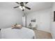 Clean bedroom with white bedding and carpeted floors, illuminated by a ceiling fan at 1531 W Colter St # 7, Phoenix, AZ 85015