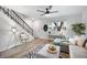 Comfortable living room with staircase, modern ceiling fan, and stylish geometric rug at 1531 W Colter St # 7, Phoenix, AZ 85015