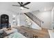 Inviting living room featuring a staircase, modern ceiling fan, and decorative accents at 1531 W Colter St # 7, Phoenix, AZ 85015