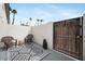 Private patio with a black and white rug, seating, enclosed by concrete walls and a gate at 1531 W Colter St # 7, Phoenix, AZ 85015