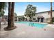 Community pool featuring lounge chairs and covered seating areas at 1531 W Colter St # 7, Phoenix, AZ 85015