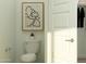 Bright bathroom featuring a standard toilet, modern art, and neutral tones at 15806 W Kendall St, Goodyear, AZ 85338