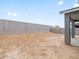 The backyard is dirt and surrounded by a tall block wall for privacy at 16076 W El Cortez Pl, Surprise, AZ 85387