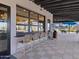 Poolside bar area with barstool seating looking through a large window at 16076 W El Cortez Pl, Surprise, AZ 85387