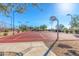 Outdoor basketball court with a red surface, surrounded by desert landscaping at 1631 N Lynch --, Mesa, AZ 85207