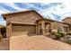 Charming brick home featuring a two-car garage and welcoming front porch, set against a beautiful blue sky at 1631 N Lynch --, Mesa, AZ 85207