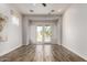 Bright living room featuring wood floors, and french doors overlooking the pool at 1631 N Lynch --, Mesa, AZ 85207