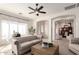 Elegant living room with a tufted sofa, arched doorways, and ample natural light creates a sophisticated ambiance at 1631 N Lynch --, Mesa, AZ 85207