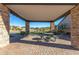 Outdoor covered patio features brick flooring, stone columns, and seating area at 1631 N Lynch --, Mesa, AZ 85207