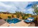 Inviting backyard pool with waterfall feature and blue lounge chairs, perfect for relaxation at 1631 N Lynch --, Mesa, AZ 85207