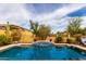 Inviting pool with a water feature and lush landscaping offers a serene backyard oasis at 1631 N Lynch --, Mesa, AZ 85207