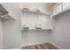 Bright walk-in closet featuring white shelves and wood laminate flooring at 1631 N Lynch --, Mesa, AZ 85207