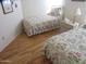 Inviting bedroom featuring twin beds with floral bedding and wood-look flooring at 1720 E Augusta Ave, Chandler, AZ 85249