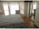 A bedroom with a large window, a mirrored closet door and wood floor at 1720 E Augusta Ave, Chandler, AZ 85249