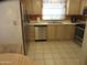 Galley kitchen with stainless steel appliances, tiled floor, and ample counter space at 1720 E Augusta Ave, Chandler, AZ 85249