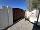 Backyard gate with desert landscaping, providing a private and serene outdoor space at 19045 N 45Th Ave, Glendale, AZ 85308