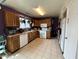 A functional kitchen with ample cabinet space, modern appliances, and durable tile flooring for easy maintenance at 19045 N 45Th Ave, Glendale, AZ 85308