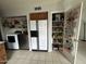 An organized laundry and pantry area with shelving, modern appliances, and plenty of storage for household needs at 19045 N 45Th Ave, Glendale, AZ 85308