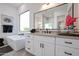 Stylish bathroom features a soaking tub, modern sink, and bright natural light at 1920 E Creek Canyon Rd, Phoenix, AZ 85086