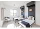 Modern bedroom with two twin beds, stylish black accent walls, and unique decorative lighting at 1920 E Creek Canyon Rd, Phoenix, AZ 85086