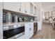 Elegant kitchen area with built-in microwave, wine cooler, modern backsplash, and wood-style tile floors at 1920 E Creek Canyon Rd, Phoenix, AZ 85086