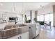 Up-close view of the kitchen island, stainless steel sink, and open-concept layout at 1920 E Creek Canyon Rd, Phoenix, AZ 85086