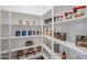 Well-organized walk-in pantry with white shelving stocked with a variety of food and household items at 1920 E Creek Canyon Rd, Phoenix, AZ 85086