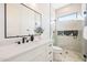 Elegant bathroom with black fixtures, a large vanity mirror, and a glass-enclosed shower at 1940 E Creek Canyon Rd, Phoenix, AZ 85086