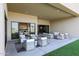 Spacious covered patio with multiple seating areas and artificial turf at 1940 E Creek Canyon Rd, Phoenix, AZ 85086