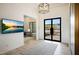 Modern entryway featuring a decorative light fixture, front door, and an adjacent office space at 1940 E Creek Canyon Rd, Phoenix, AZ 85086