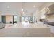 Spacious kitchen island with a waterfall countertop, seating, and views of the backyard at 1940 E Creek Canyon Rd, Phoenix, AZ 85086